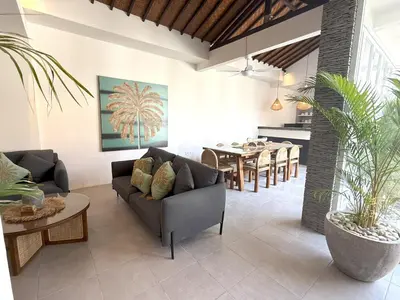 a living room with a couch and a table at Villa KAS Legian Seminyak - 6 Bedroom Villa in Seminyak