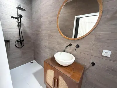 a bathroom with a sink and a mirror at Villa KAS Legian Seminyak - 6 Bedroom Villa in Seminyak