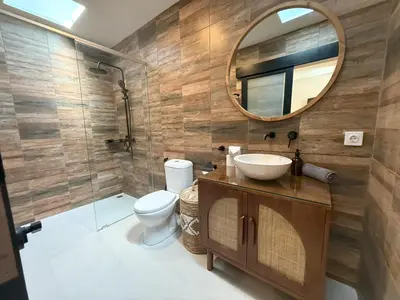 a bathroom with a toilet and a mirror at Villa KAS Legian Seminyak - 6 Bedroom Villa in Seminyak