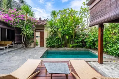 a swimming pool in front of a house at 3-Bedroom Villa near Kudeta Beach - Oberoi Street By iBali Management in Seminyak