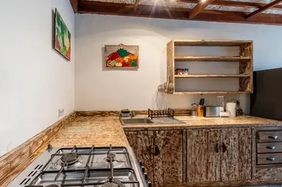 a kitchen with a stove and a counter top at 3-Bedroom Villa near Kudeta Beach - Oberoi Street By iBali Management in Seminyak