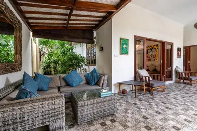 a living room with a couch and a table at 3-Bedroom Villa near Kudeta Beach - Oberoi Street By iBali Management in Seminyak