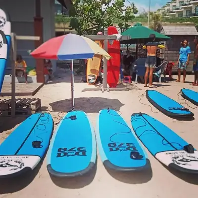 a group of surfboards sitting on the beach at inadreadboy surfclass in Legian