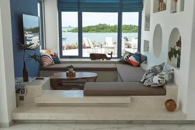 a living room with a couch and a large window at Stunning Sea Front Villa 4BR Nusa Dua in Badung