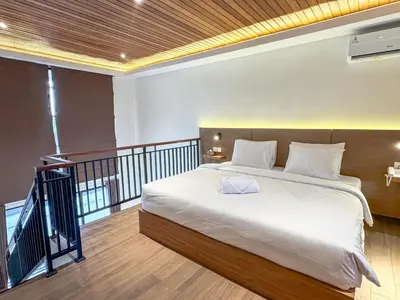 a bedroom with a large bed on a balcony at Olala Loft Seminyak in Seminyak