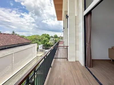 a balcony with a view of the city at Olala Loft Seminyak in Seminyak