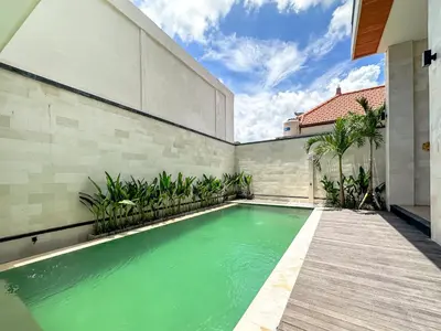 a swimming pool in the backyard of a house at Olala Loft Seminyak in Seminyak