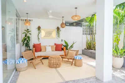 a patio with a couch and chairs and plants at 5BR Private Pool Villa - 1 min Beach - Daily Staff, Private Pool, Gym & Games in Canggu