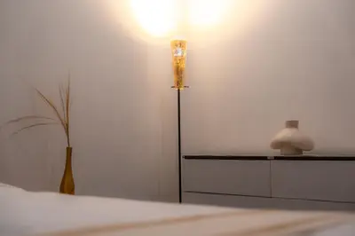 a room with a lamp and a dresser with a vase at 5BR Private Pool Villa - 1 min Beach - Daily Staff, Private Pool, Gym & Games in Canggu