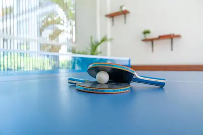 a ping pong ball in a ping paddle on a table at 5BR Private Pool Villa - 1 min Beach - Daily Staff, Private Pool, Gym & Games in Canggu