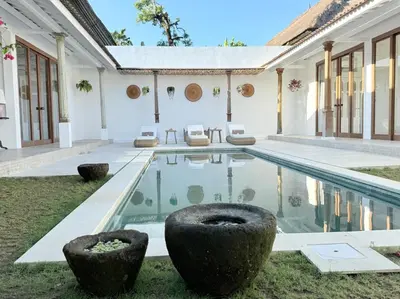 a house with a swimming pool and a yard at Villa Gamelan Bohème Chic Bali in Seminyak