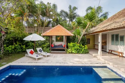 a villa with a swimming pool and a house at Tropical Oasis of Calm in the Heart of Seminyak, 4BR Villa Luisha in Seminyak