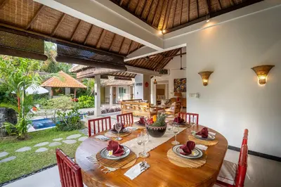 a dining room with a wooden table and chairs at Tropical Oasis of Calm in the Heart of Seminyak, 4BR Villa Luisha in Seminyak