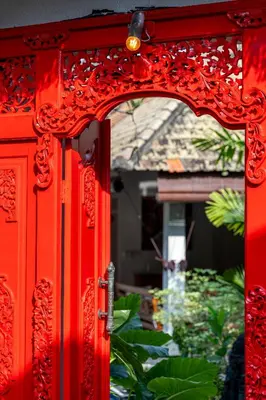 a red door with a mirror in front of a house at Tropical Oasis of Calm in the Heart of Seminyak, 4BR Villa Luisha in Seminyak