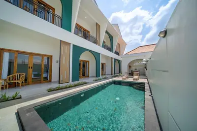 a swimming pool in the middle of a house at D'Gangga Residence By Bali Cabin in Kerobokan