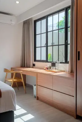a desk in a room with a large window at Villa Loema in Kerobokan