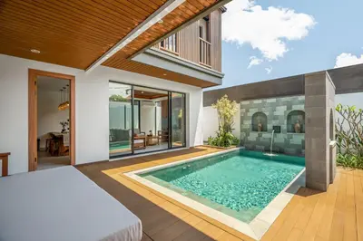a bedroom with a swimming pool in a villa at Villa Loema in Kerobokan