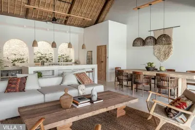 a living room with a white couch and a table at Villa Massilia Bali in Seminyak