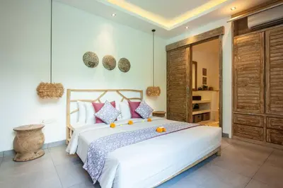 a bedroom with a large white bed with oranges on it at Modern 4bd villa, amazing location in Seminyak in Seminyak