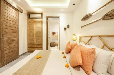 a bedroom with a bed with oranges on it at Modern 4bd villa, amazing location in Seminyak in Seminyak