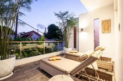 an outdoor patio with a chair and a table at Modern 4bd villa, amazing location in Seminyak in Seminyak