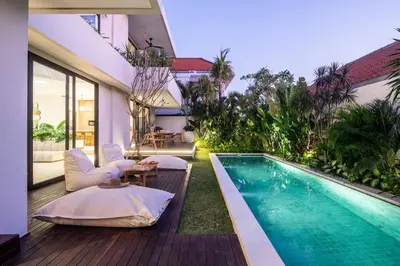 a backyard with a swimming pool and a house at Luxurious 5 bd villa in Seminyak - art deco style in Canggu