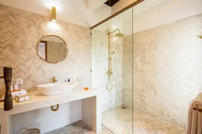 a bathroom with a sink and a glass shower at Luxurious 5 bd villa in Seminyak - art deco style in Canggu