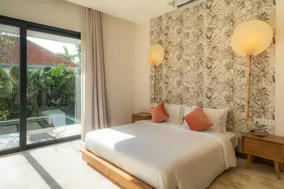 a bedroom with a bed and a large window at Luxurious 5 bd villa in Seminyak - art deco style in Canggu