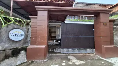 a entrance to a building with a wooden door at Wresni guesthouse in Canggu