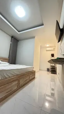 a bedroom with a bed and a table in it at Graha Shanti Guest House in Pulau Serangan