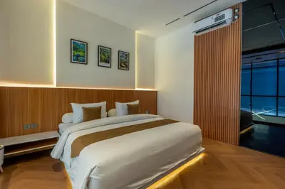 a bedroom with a large bed and a large window at 1BR Modern Loft near Airport in Pesanggaran