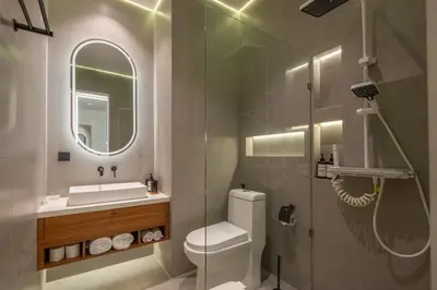 a bathroom with a toilet and a sink and a mirror at 1BR Modern Loft near Airport in Pesanggaran
