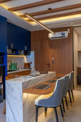 a kitchen with a large marble counter and chairs at 1BR Modern Loft near Airport in Pesanggaran