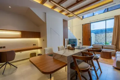 a kitchen and dining room with a table and chairs at 1BR Modern Loft near Airport in Pesanggaran