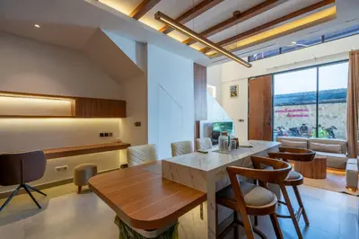 a kitchen with a table and chairs in a room at 2BR Modern Suites near Airport in Pesanggaran