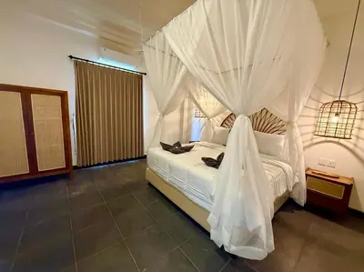 a bedroom with a canopy bed with white curtains at Villa AYLA - Legian - 5 Bedrooms - 5 Bathrooms in Seminyak
