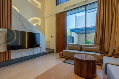 a living room with a couch and a tv at 1BR Stylish Loft near airport in Pesanggaran