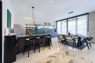 a kitchen and dining room with a table and chairs at Damai Suite Relax & Comfort in Canggu 3BR in Canggu