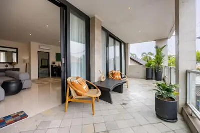 a living room with a couch and a table and chairs at Damai Suite Relax & Comfort in Canggu 3BR in Canggu