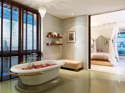 a bathroom with a bath tub with a bedroom at Villa Lilibel by Elite Havens in Seminyak