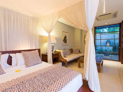 a bedroom with a large bed and a window at Villa Lilibel by Elite Havens in Seminyak