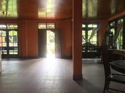 an empty room with orange walls and a door at Nyoman Legian House in Legian