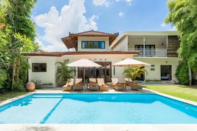 a villa with a swimming pool and a house at Villa Vista 2 Seminyak in Seminyak