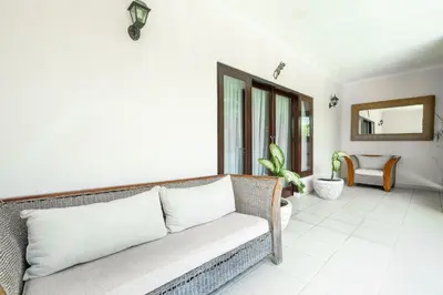 a living room with a couch and a mirror at Villa Vista 2 Seminyak in Seminyak