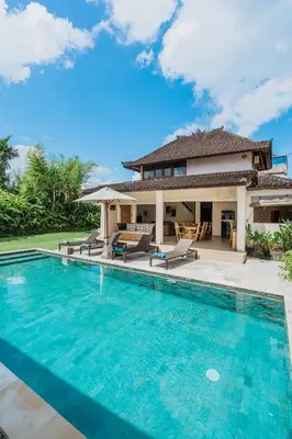 a villa with a swimming pool and a house at Villa Vista 3 Seminyak in Seminyak