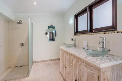 a bathroom with two sinks and a shower at Villa Vista 3 Seminyak in Seminyak