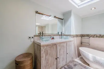 a bathroom with two sinks and a tub and a mirror at Villa Vista 3 Seminyak in Seminyak