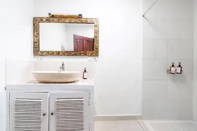 a bathroom with a sink and a mirror at 10 Bedroom Villa Vista Seminyak in Seminyak