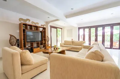 a living room with two couches and a television at 10 Bedroom Villa Vista Seminyak in Seminyak