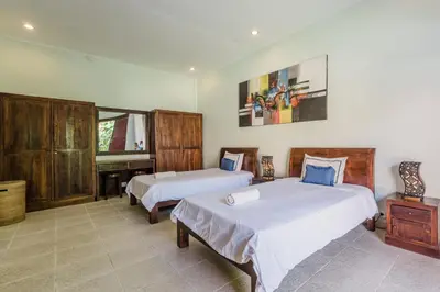 a bedroom with two beds and a piano at 10 Bedroom Villa Vista Seminyak in Seminyak
